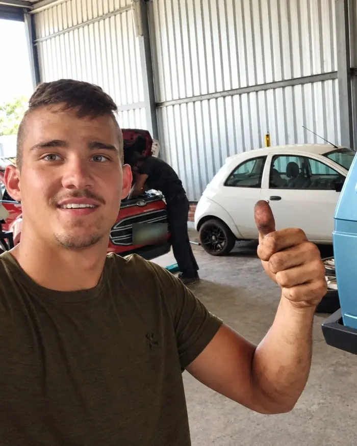 Joe Webb giving a thumbs up in the JHH Auto Worx workshop
